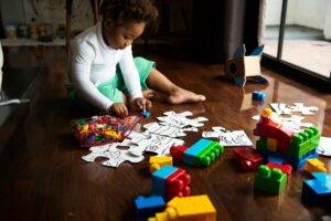Child playing with blocks and large puzzle pieces