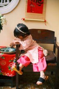 Child having tea. Asian tea tradition